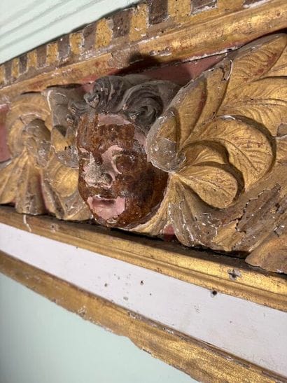 Carved wood paneling with ochre and white...