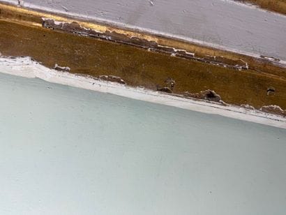 Carved wood paneling with ochre and white...
