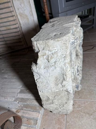 Stone carved with a coat of arms surmounted...