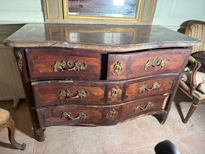 An important chest of drawers with a curved...