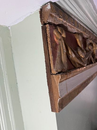 Carved wood paneling with ochre and white...