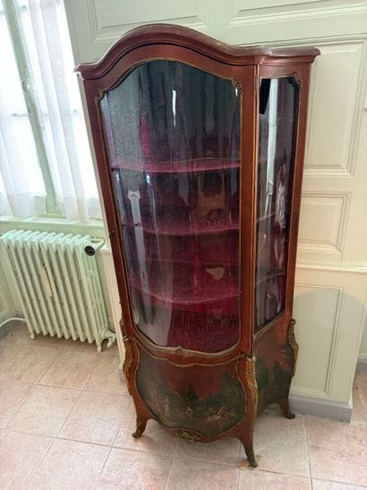 A veneered wood display case, decorated in...