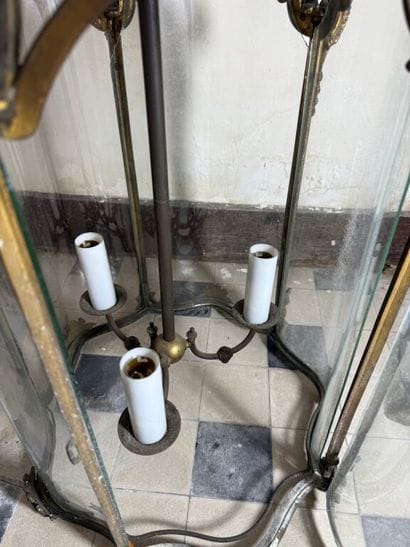 A large three-armed cage chandelier in molded...