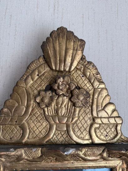 Small pediment mirror in carved and gilded...