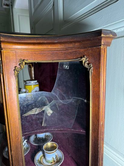 A veneered wood display case, decorated in...
