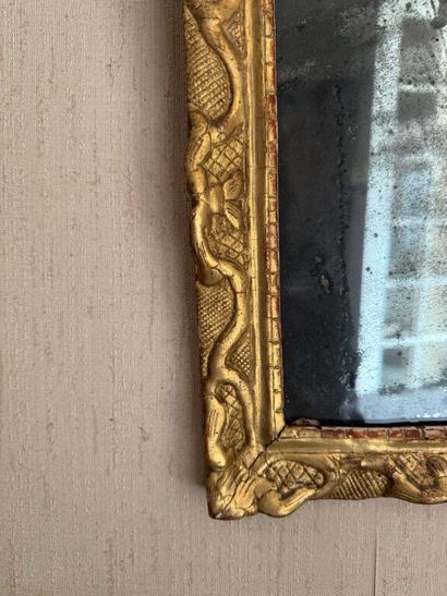 Small pediment mirror in carved and gilded...