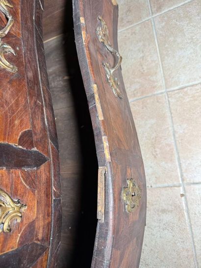 An important chest of drawers with a curved...