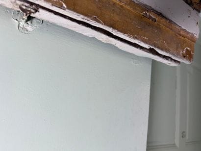 Carved wood paneling with ochre and white...