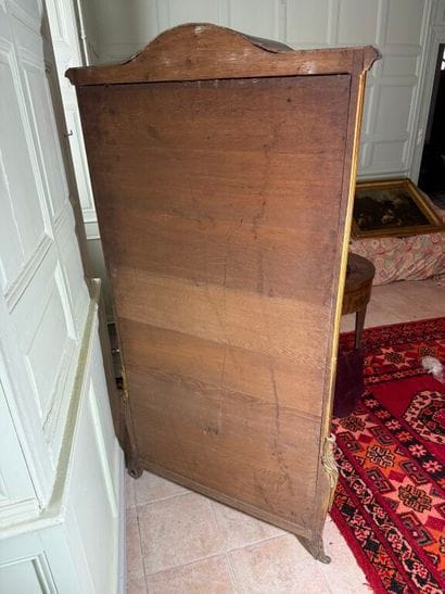 A veneered wood display case, decorated in...
