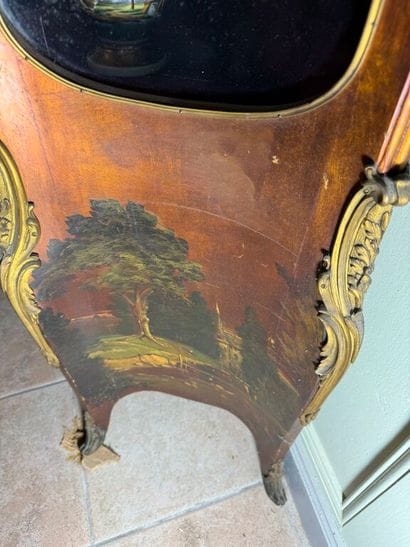 A veneered wood display case, decorated in...