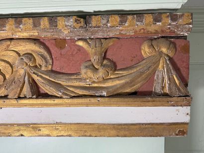 Carved wood paneling with ochre and white...