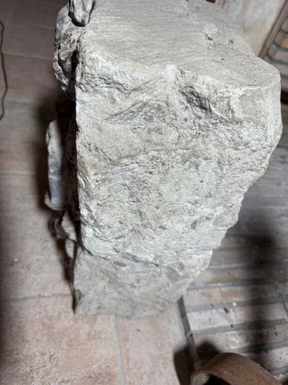 Stone carved with a coat of arms surmounted...