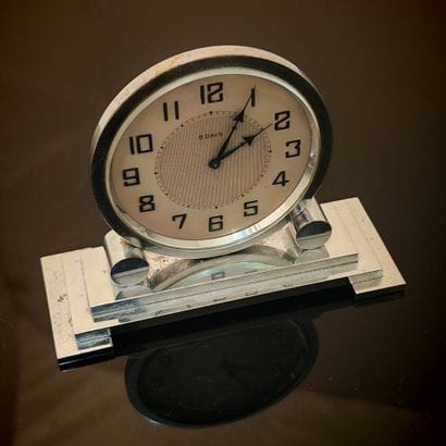 Anonymous. Polished steel table clock on...