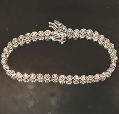 A small tennis bracelet in white gold set...
