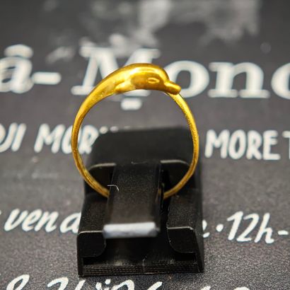 750‰ gold cross ring featuring a dolphin...