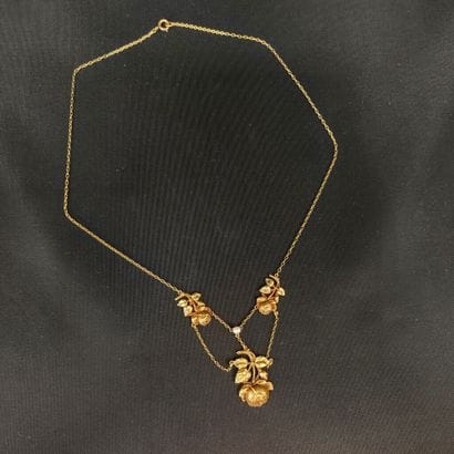 Yellow gold necklace adorned with rose motifs,...