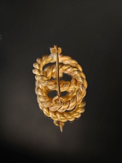 A 750‰ gold brooch featuring two intertwined...