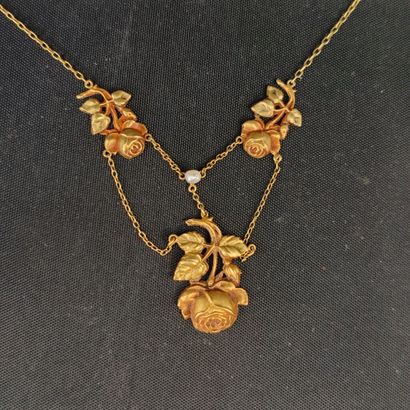 Yellow gold necklace adorned with rose motifs,...
