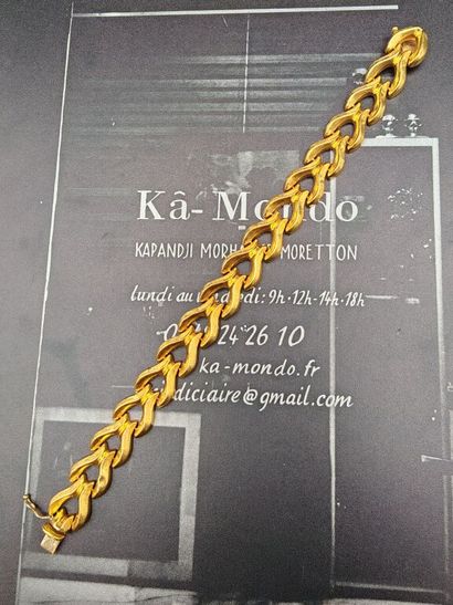 A small, textured 750‰ gold bracelet made...