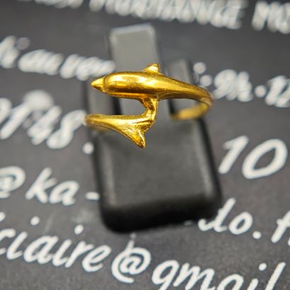 750‰ gold cross ring featuring a dolphin...