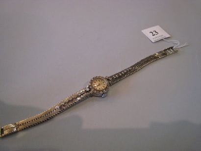 Montre de dame en or gris cadran rond, bracelet...
