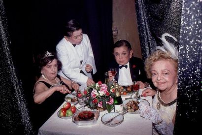 LITTLE PEOPLE DINING IN A LUCITE COLUMN.
By...