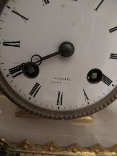 Clock in gilded metal and stone representing...
