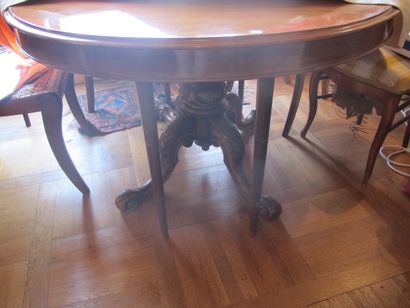 Natural wood pedestal table forming a dining...