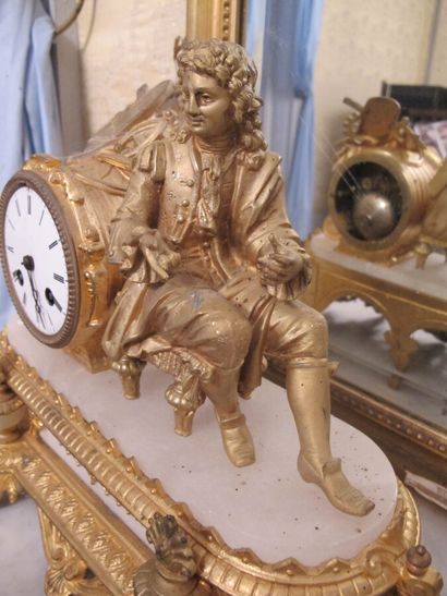 Clock in gilded metal and stone representing...