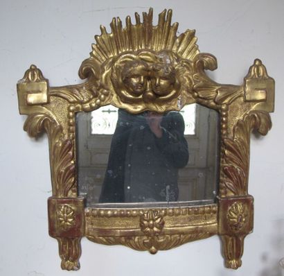 Gilded wooden mirror with putti decoration...