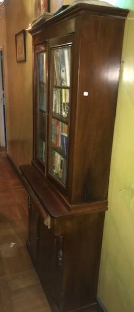 Small mahogany bookcase with two glass doors...