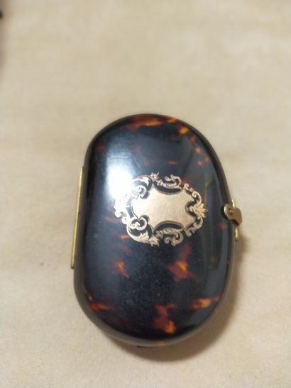 Oval tortoise shell purse decorated with...