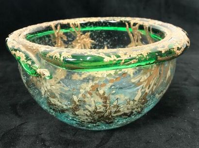 A round glass bowl decorated with gold inclusions...
