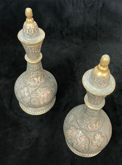A pair of bronze prophylactic flasks, the...