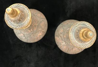 A pair of bronze prophylactic flasks, the...