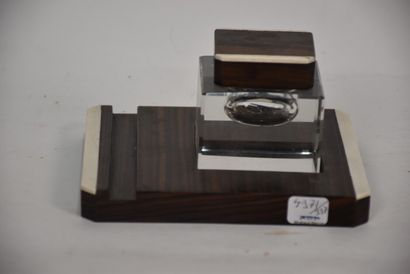 Glass inkwell resting on a macassar ebony...