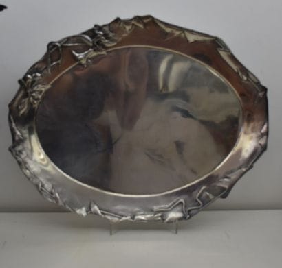 A silver oval tray with flowers and foliage...