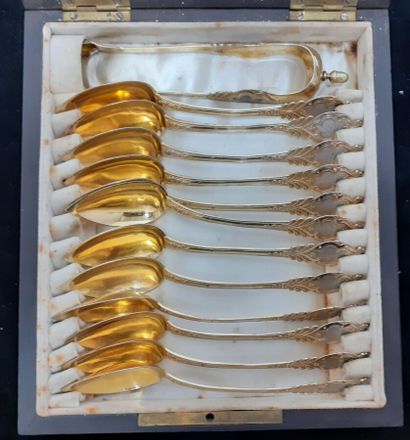 Twelve vermeil tea spoons and sugar tongs...