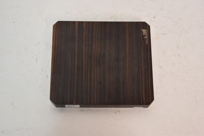 Glass inkwell resting on a macassar ebony...