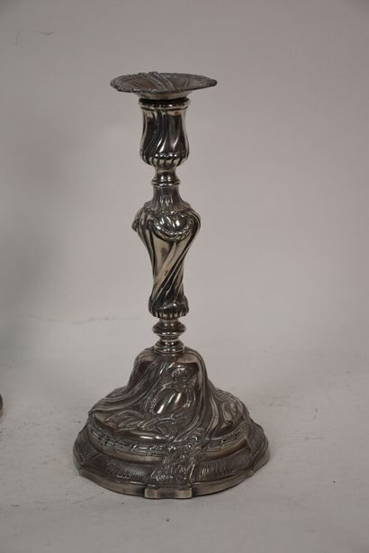 A pair of silver plated bronze torches in...