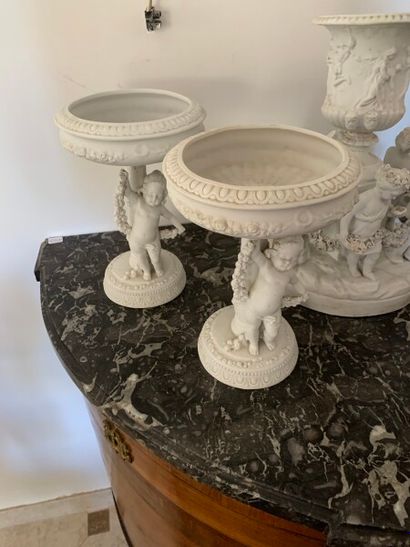 Pair of biscuit cups supported by putti 

Height:...