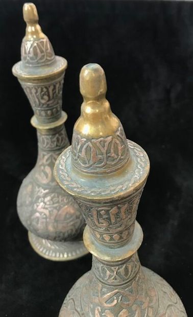 A pair of bronze prophylactic flasks, the...