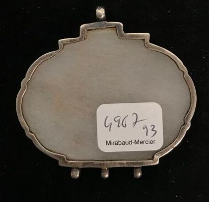 A white nephrite oval pendant engraved with...