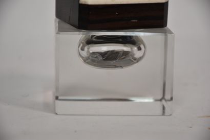 Glass inkwell resting on a macassar ebony...