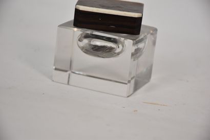 Glass inkwell resting on a macassar ebony...