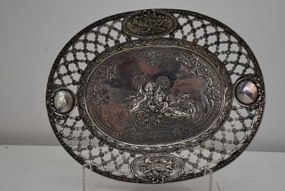 An oval silver banner with putti decoration,...