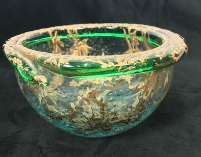 A round glass bowl decorated with gold inclusions...