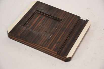 Glass inkwell resting on a macassar ebony...