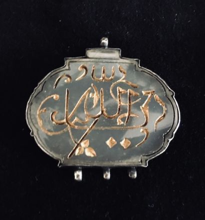 A white nephrite oval pendant engraved with...