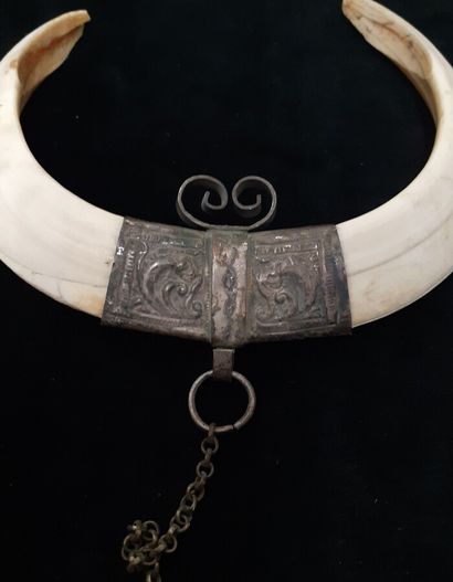 Three metal pendants with warthog teeth 

North...